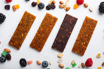 Healthy fitness energy bars with dried fruits, top view, on white background