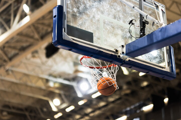 Basket ball and a basketball glass board with rim.