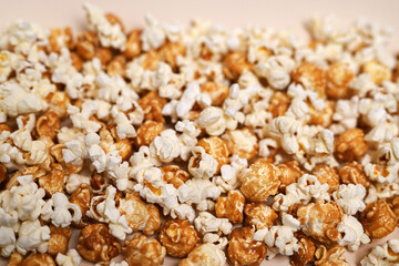 Popcorn background. Caramel popcorn and salted popcorn mixed together. Close-up, shallow depth of field, top view