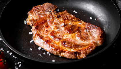 Frying pan with grilled steak. 