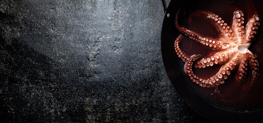 Octopus is boiled in a pot of water.  © Artem Shadrin