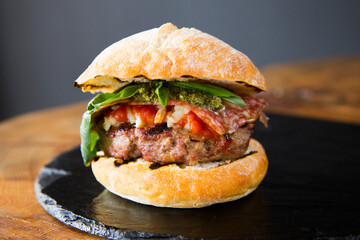 Authentic top quality American Burger with salami and pesto.