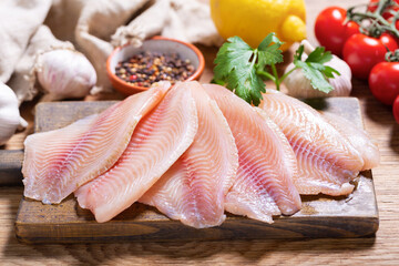 fresh fish fillet of tilapia with ingredients for cooking