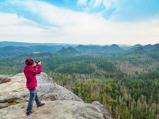Travel hike woman hiker taking photo with phone of landscape of trail hiking