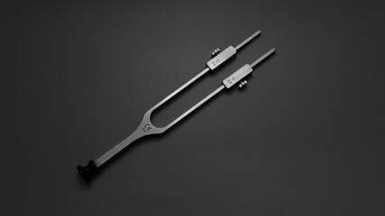 Fototapeta premium tuning fork C 128 on a grey background with gradation