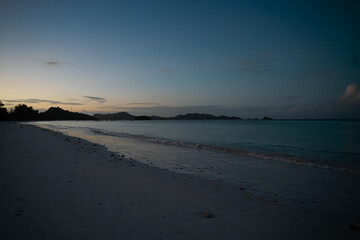 View along the long beach of Anse Volbert in the evening.