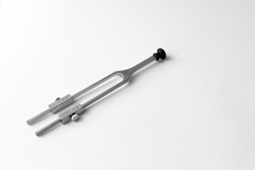 tuning fork C 128 on a white background with gradation