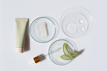 Glass petri dish with transparent pure serum for skin care