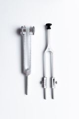 tuning fork C 128 on a white background with gradation, medical instruments, equipment