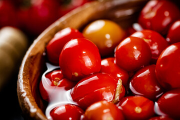 Pickled tomatoes on a plate. Macro background.
