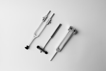 tuning fork C 128 on a white background with gradation and neurological hammer