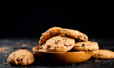 Delicious cookies with pieces of milk chocolate on a plate.