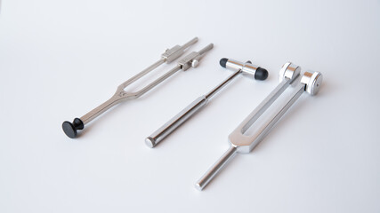 tuning fork C 128 on a white background with gradation and neurological hammer, medical instruments, equipment