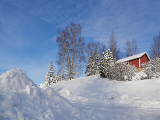 Fototapeta na wymiar Winter road in Northern Europe: lots of snow, blue sky, Finland, Kerava.