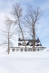 Poster Pretty low angle vertical landscape with patrimonial presbytery on snowy hill surrounded by bare trees in the Cap-Rouge area of Quebec City during a winter day, Quebec City, Quebec, Canada © Anne Richard