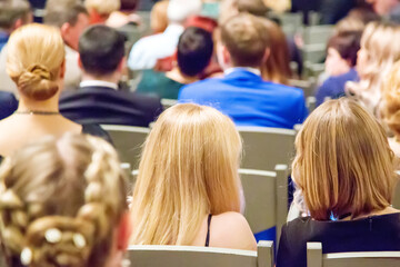 Rear view of audience in the conference hall or seminar business meeting. Business symposium