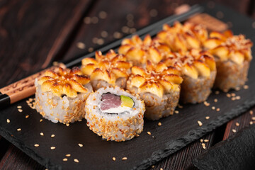 Sushi roll with smoked tuna with avocado and cheese close-up. Traditional delicious fresh sushi roll set. Sushi menu. Japanese cuisine restaurant. Asian food