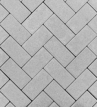 Top view of a gray brick outdoor flooring in a zig zag pattern