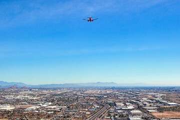 Aerial view from beneath a commercial airliner on approach to a desert international airport