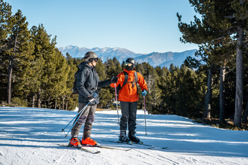 Fototapeta na wymiar Two boys talking on a ski slope.