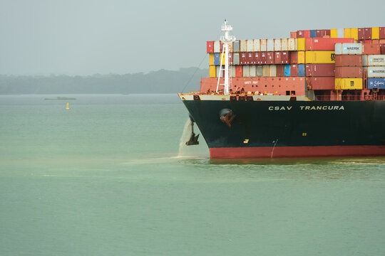 Container ship Trancura raising anchor on Gatun lake, Panama canal