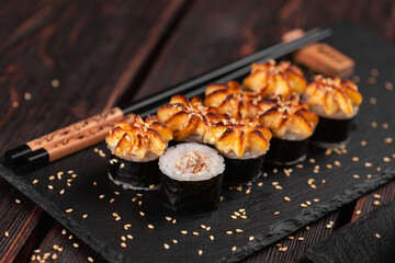 Japanese hot maki roll sushi with eel close-up - asian food concept