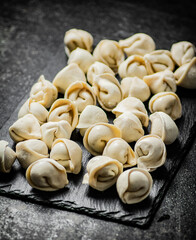 Raw dumplings on a stone board. 