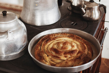 Roll pastry cooked in a wood stove. Title: on a white background Turkish Tepsi Boregi, Round Borek, Tray pastry (Turkish name; rulo borek)