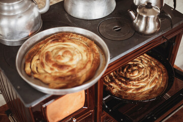 Roll pastry cooked in a wood stove. Title: on a white background Turkish Tepsi Boregi, Round Borek, Tray pastry (Turkish name; rulo borek)