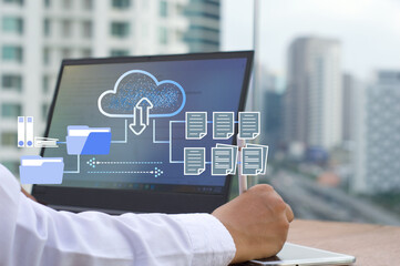 businessman  working on a laptop using FTP (File Transfer Protocol) with a paperless system