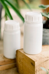 Liquid and solid vermicompost in plastic bottles and straws.