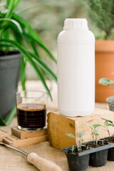 Liquid and solid vermicompost in plastic bottles and straws.