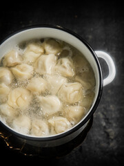 Dumplings are boiled in a saucepan in boiling water. 