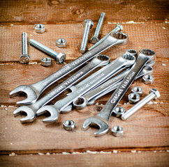 Wrenches with nuts on the table. 