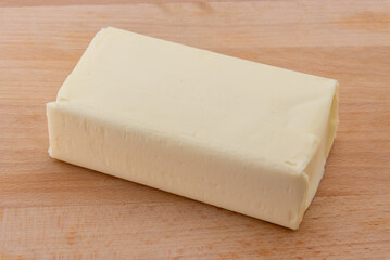 Block of butter on wooden cutting board