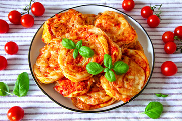 Puff pastry snacks with tomatoes sauce and cheese