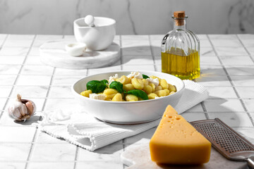 gnocchi with mozzarella and basil on a white background