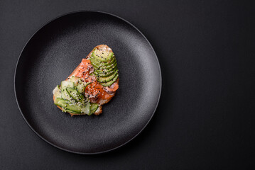 Fresh tasty sandwich with salmon, avocado and sesame and flax seeds