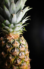 Juicy Whole Pineapple With Green Leaves Isolated On Black Background