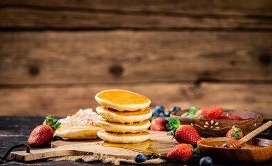 Homemade pancakes with honey on the table. 