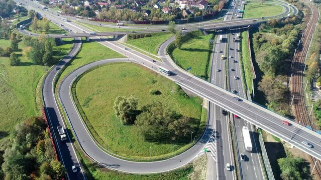 Highway multilevel crossing. Interchange junction on A4 international highway with Zakopianska multilane street and railway, the part of freeway around Krakow, Poland. Aerial view from above