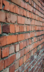 Red brick wall. City buildings. Brick background. Repair, construction. Weathered stained old brick...