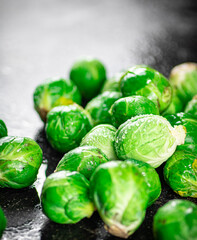 A pile of Brussels cabbage on the table. 