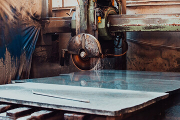 A stone cutter processes stone and granite slabs in the industry
