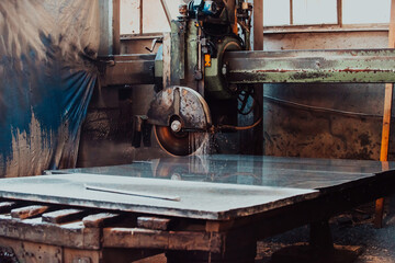 A stone cutter processes stone and granite slabs in the industry