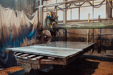 A stone cutter processes stone and granite slabs in the industry