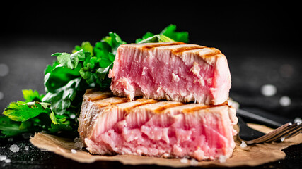 Grilled tuna with parsley on the table. 