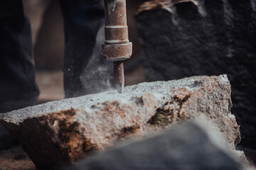 A stone pierces a factory worker. Heavy stone processing industry