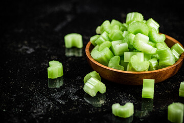 Pieces of fresh celery in a wooden plate. 