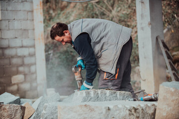 Fototapeta na wymiar A stone pierces a factory worker. Heavy stone processing industry